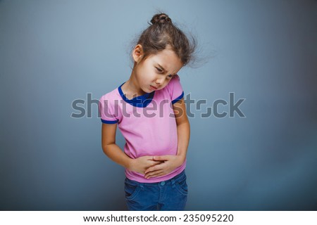 Teen girl child abdominal pain on a gray background