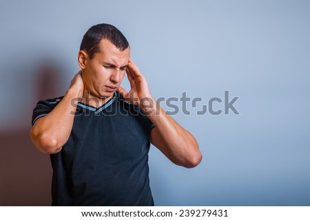 European-looking the man holding his hands behind his head and neck pain