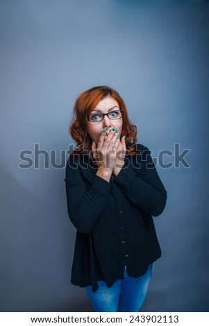 European - looking  woman 30 years  his  hands  over his mouth