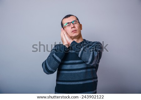European-looking man of 30 years in glasses  wants to  sleep