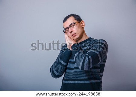 European-looking man of 30 years in glasses wants to sleep