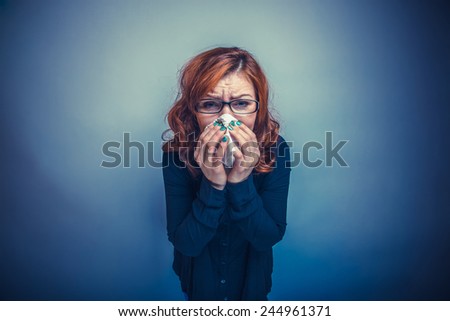European-looking woman of 30 years is sick, sneezing, handkerchief cross process