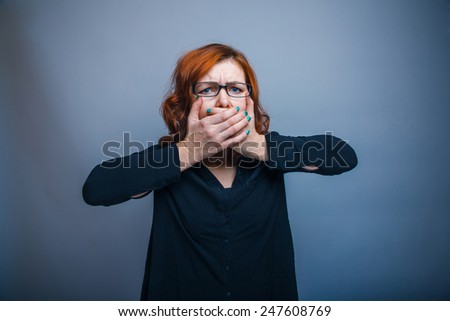 European - looking  woman thirty years  his hands over  his mouth
