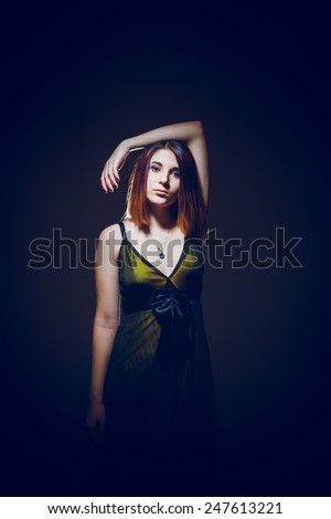 portrait of a young girl of the European appearance haired on a gray background cross process