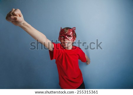Boy teenager twelve years in  red shirt in  mask, super  hero