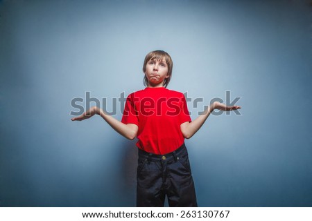 Boy, teenager, twelve years in red T-shirt , threw up his hands, the unknown