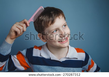 boy teenager European appearance brown hair combs pink comb
