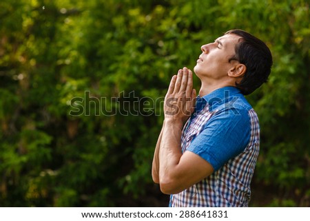 The man in the street to pray to God on a green background  leaves  summer