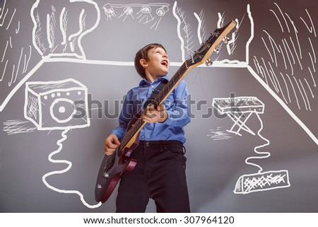 Teen boy playing guitar in the room are speakers synth rock concert infographics studio photo