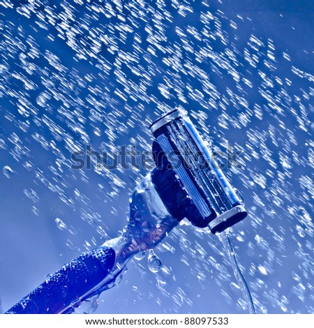 razor blade shaving kit water splash drop bubbles blue background