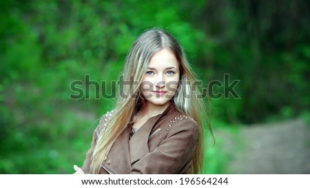 Closeup portrait of romantic fashion young woman smile in the woods.