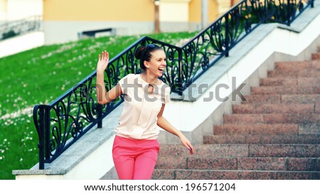 Outdoor fashion closeup portrait of young pretty laughing woman in summer sunny day on street