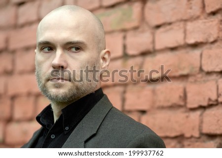 Portrait of an handsome businessman. Handsome mature man standing in front of a house.