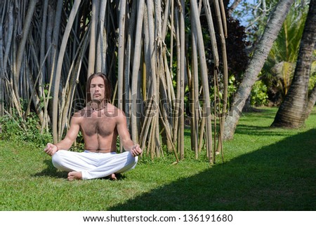 Premium Photo  A man doing yoga zen relaxation posture meditation exercise  in tropical garden