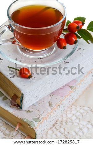 A cup of  briar tea standing on two books