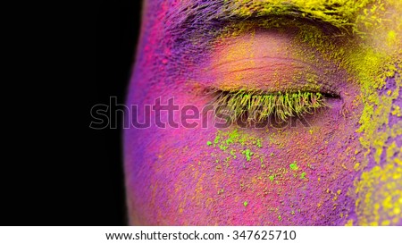 Part of face fully covered with bright holi paint