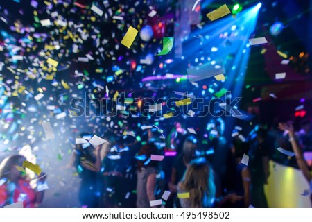Colorful confetti falling to a crowded nightclub