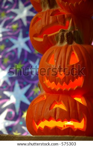 Jack O Lanterns - a stack of pumpkins carved into lighted jack-o-lanterns for Halloween.