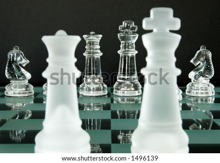 Chess game in glass.  The Queen, King and Knights from the view of the Opposing Queen and King.