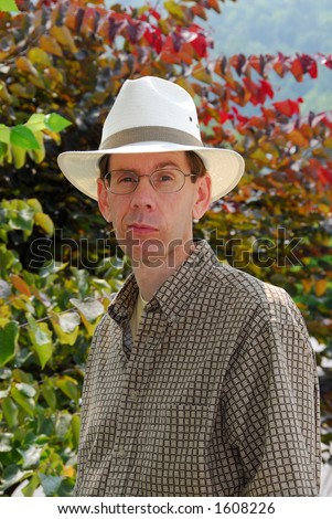 Man Expression - Portrait of a man in glasses wearing a fedora hat. Eyebrow up, apprehensive, questioning, non-believing.