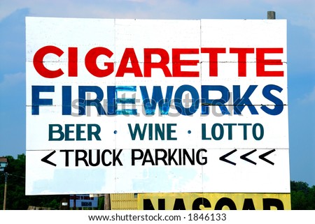 Billboard on the side of the road advertising fireworks, cigarettes, beer, wine and truck parking.