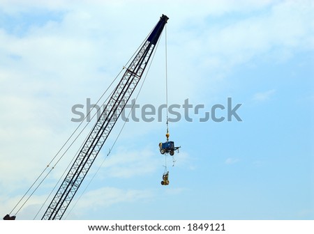 How\'s It Hangin\'? - A crane lifts expensive construction equipment overhead to ward off theft.