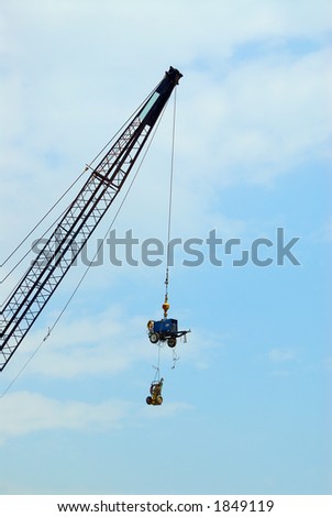 How\'s It Hangin\'? - A crane lifts expensive construction equipment overhead to ward off theft.
