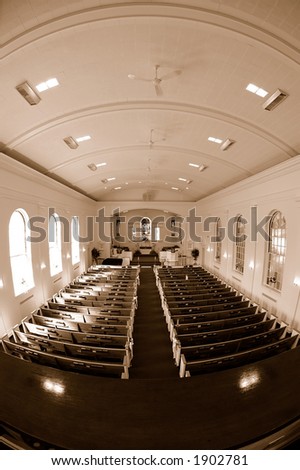 Fisheye sepia image of the interior of an empty church.