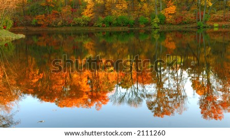 Mirror Lake - Autumn colors reflecting in the mirrored water of a lake.