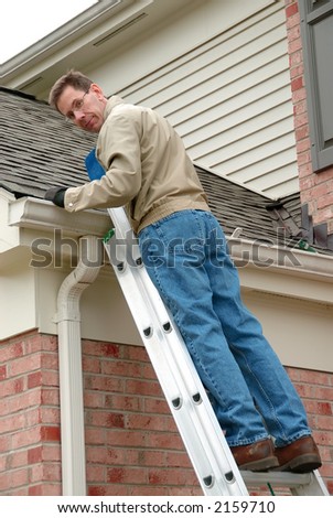 Roof Repair - Man on a ladder, cleaning the gutters and repairing the roof shingles.