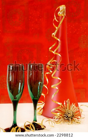 Holiday Cheer - Two green wine glasses and a red wine bottle with a cheerful holiday background.