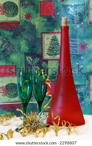 Holiday Cheer - Two green wine glasses and a red wine bottle with a cheerful holiday background.