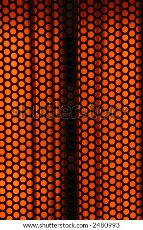 The front of an electric heater with the heating elements brightly lit and hot. Can be used as a background or overlay.