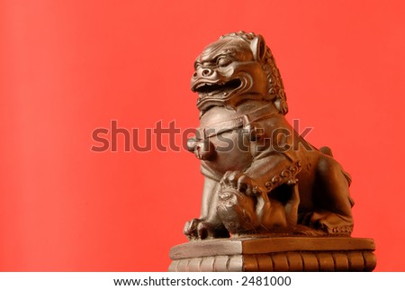 Chinese Foo Dog - A female fu dog has a single cub under her left paw and protects those dwelling inside their home.