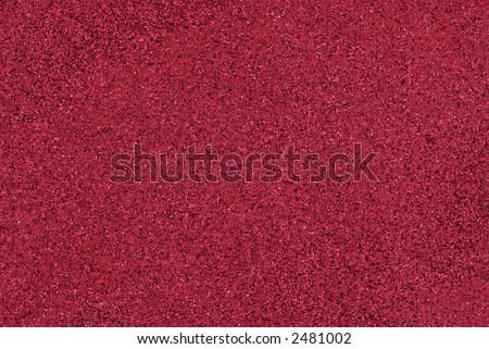 Red Sandstone Texture - a wall paint in red that has sand and other objects in it to give it texture.