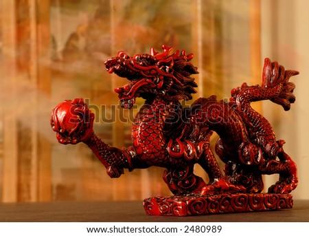 Chinese Dragon - Carved red chinese dragon with 4 toes holding a red ball.