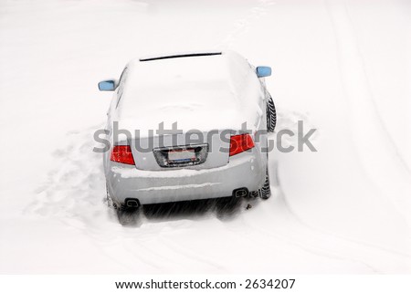 Stuck In The Snow - A car is left abandoned in a snow storm when it cannot continue up the steep hill.