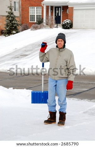 Man Shoveling Snow - A man shoveling snow on a cold winter day.