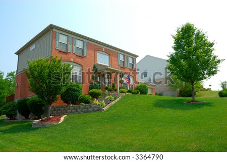 Residential 2-story brick home in an upscale suburban neighborhood.