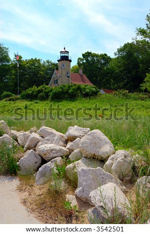 White Lake Lighthouse in Whitehall Michigan sits high on a sand dune overlooking the White Lake channel and Lake Michigan.