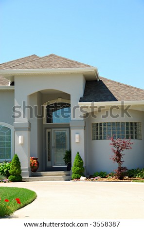Residential American Ranch House - A residential suburban home in an upscale neighborhood in the summertime.
