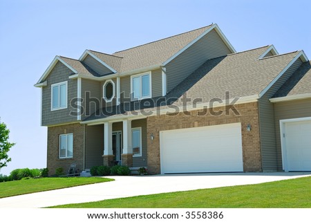 Residential American Two Story House - A residential suburban home in an upscale neighborhood in the summertime.