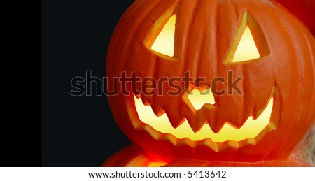 Halloween Jack O Lantern - A carved and lit jack o lantern pumpkin with space for copy.