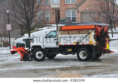 A snow plow cleaning the road in a suburban neighborhood in Kentucky, USA.