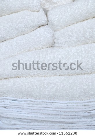 Towels And Wash Cloths Stack On Laundry Day.  A stack of folded white towels and wash cloths.