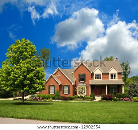 2-Story Brick Suburban Home on a sunny summer day.