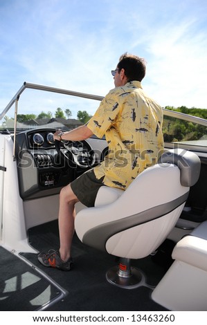 Driving a speed boat on a small lake in Kentucky, USA, interior of a boat with a man driving.
