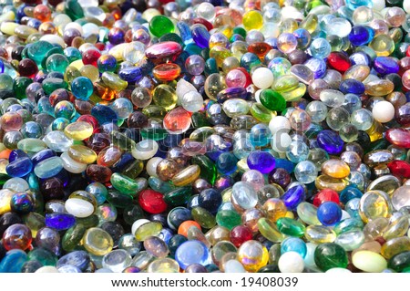 A pile of colored marbles and glass stones for use as a background texture or an overlay.