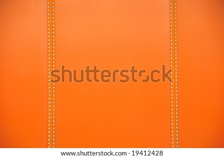 Orange surface with two lines of nails for use as a background or overlay.