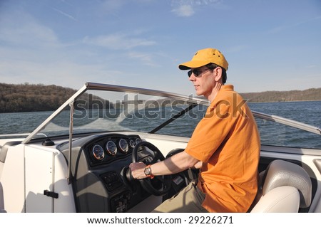 Boating In Kentucky - Man driving a boat on a lake in Kentucky, USA